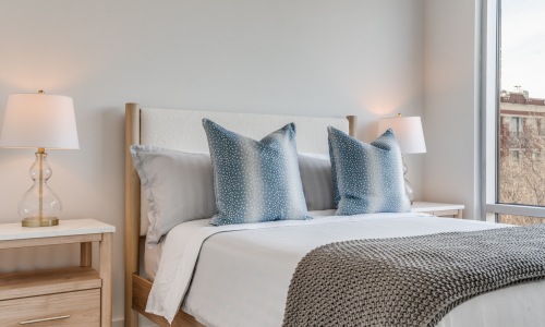 Sleep in comfortable rooms bedroom with ample space around the bed and bright lighting