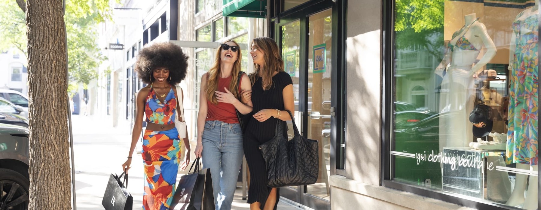 women walking in front of storefronts