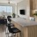 a kitchen with a bar and chairs