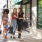 a group of women walking down a sidewalk